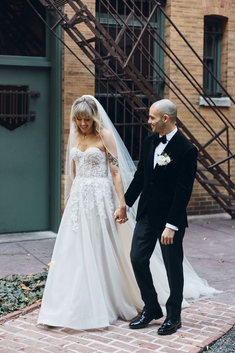 A series of wedding photos showing a couple walking together on a brick pathway next to a building with fire escapes.