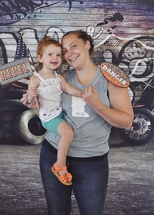 A colorful graffiti wall serves as backdrop for a casual photo shoot.