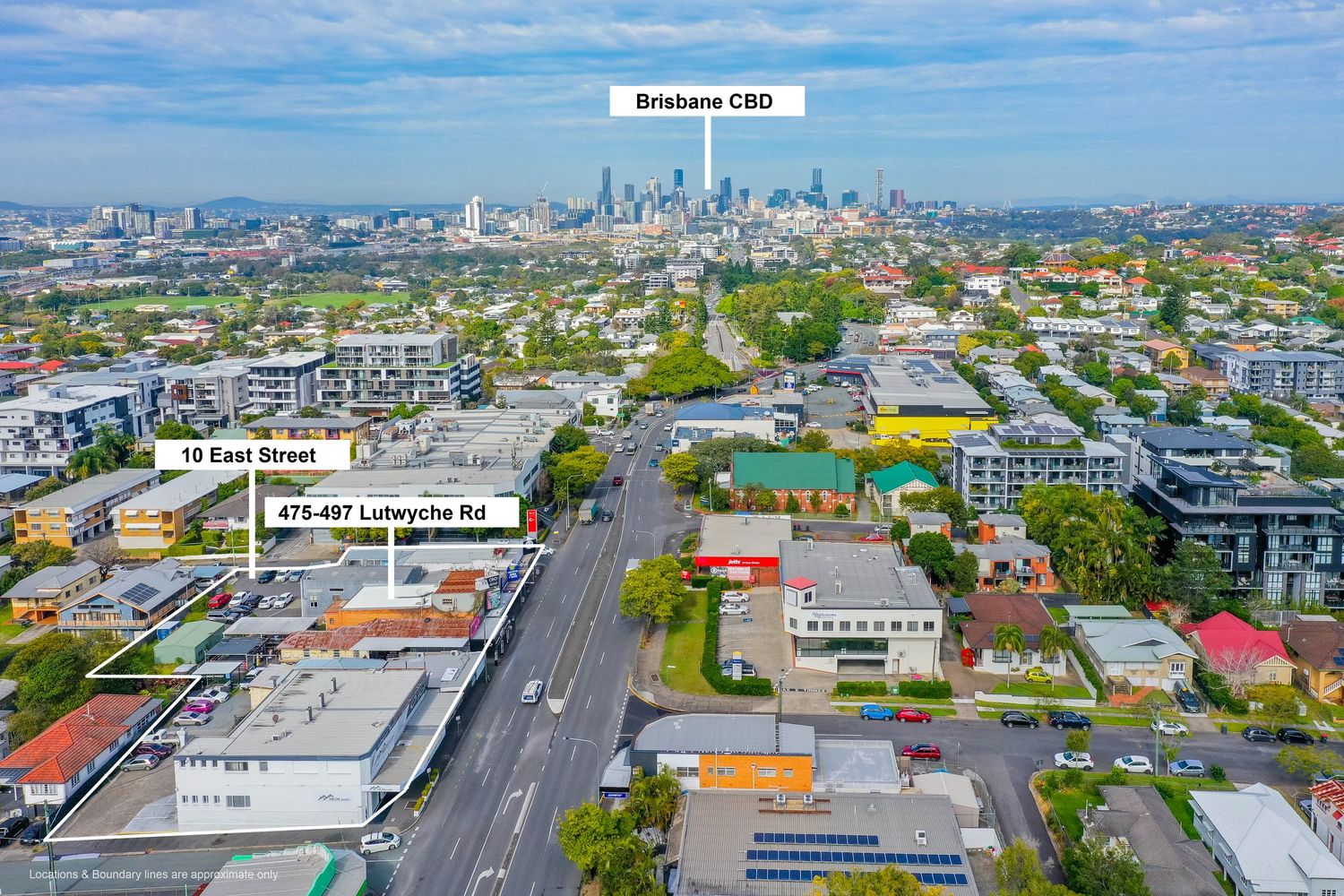 Aerial view of Lutwyche Road and East Street intersection with Brisbane CBD skyline in the background.