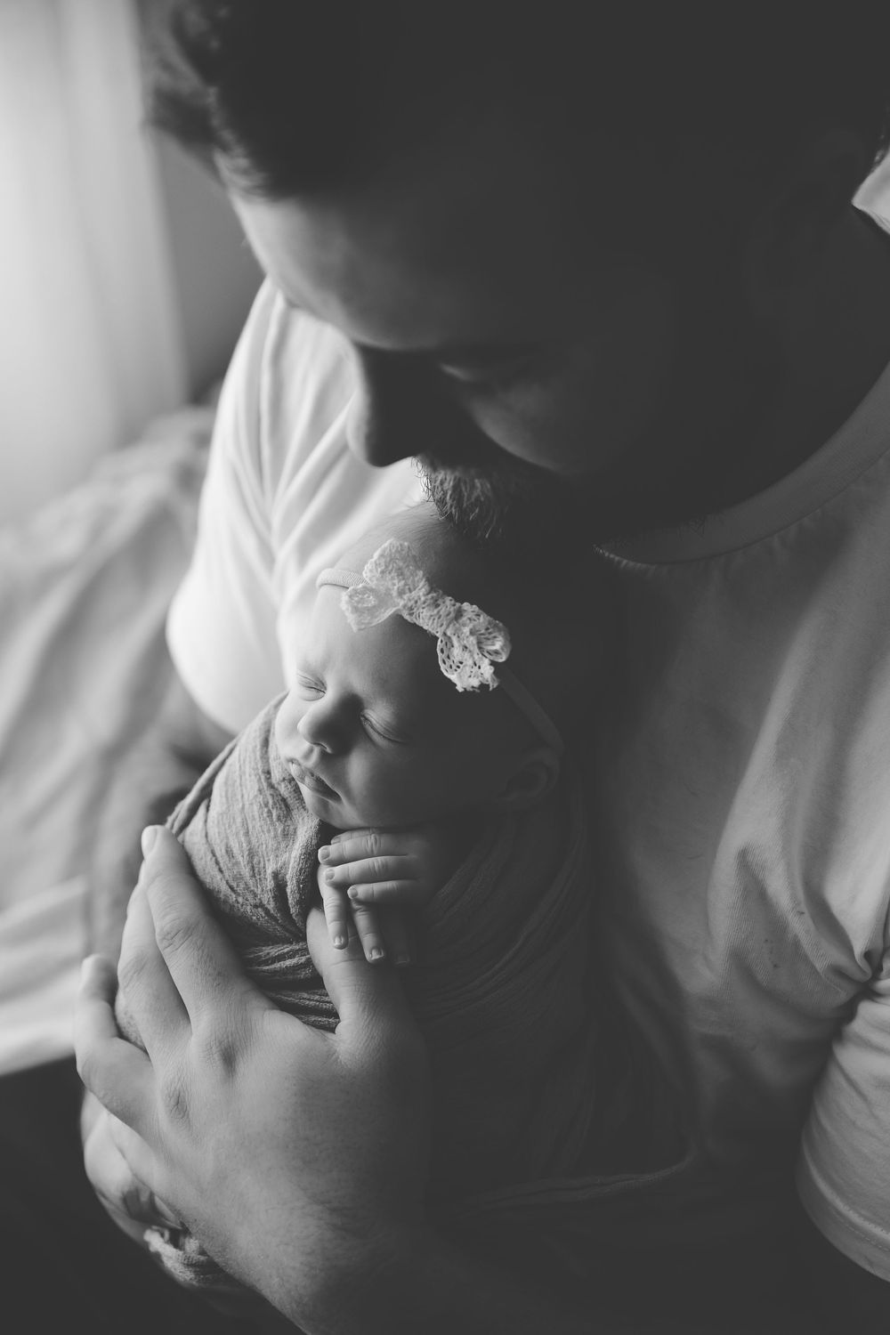 Intimate black and white close-up portraits showing tender moments between a couple.