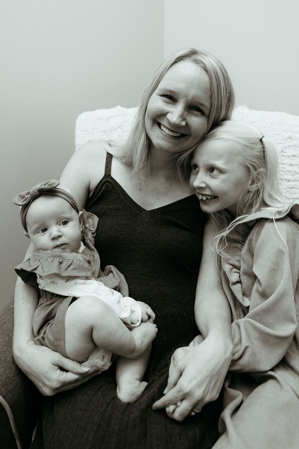 Black and white portrait of family members sharing intimate moments together. In-home family portraits in central Michigan.