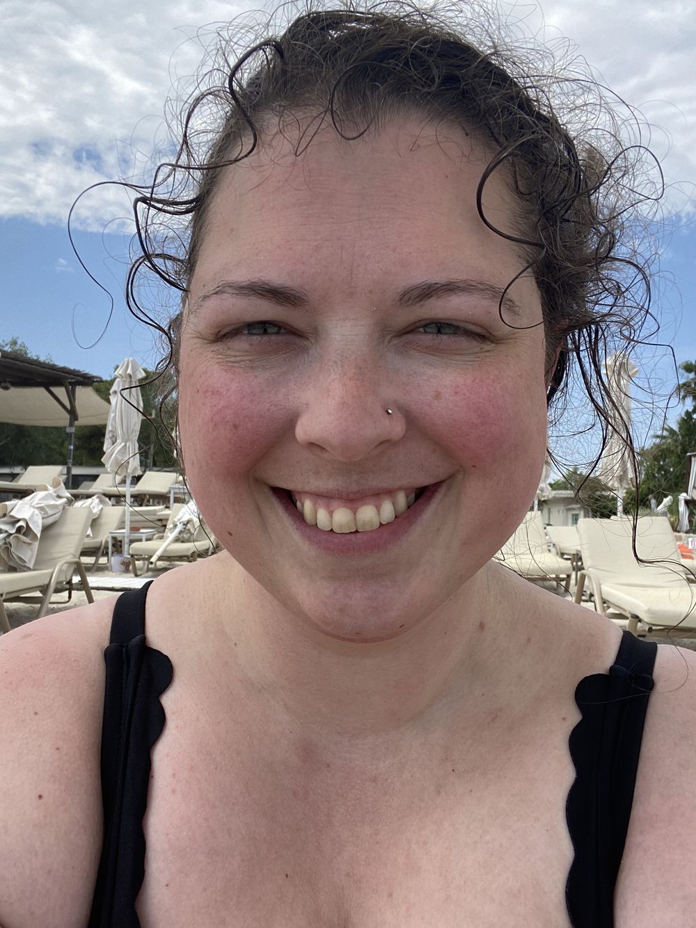 A series of selfie photos showing a person with curly dark hair and a bright smile at a sunny outdoor location.