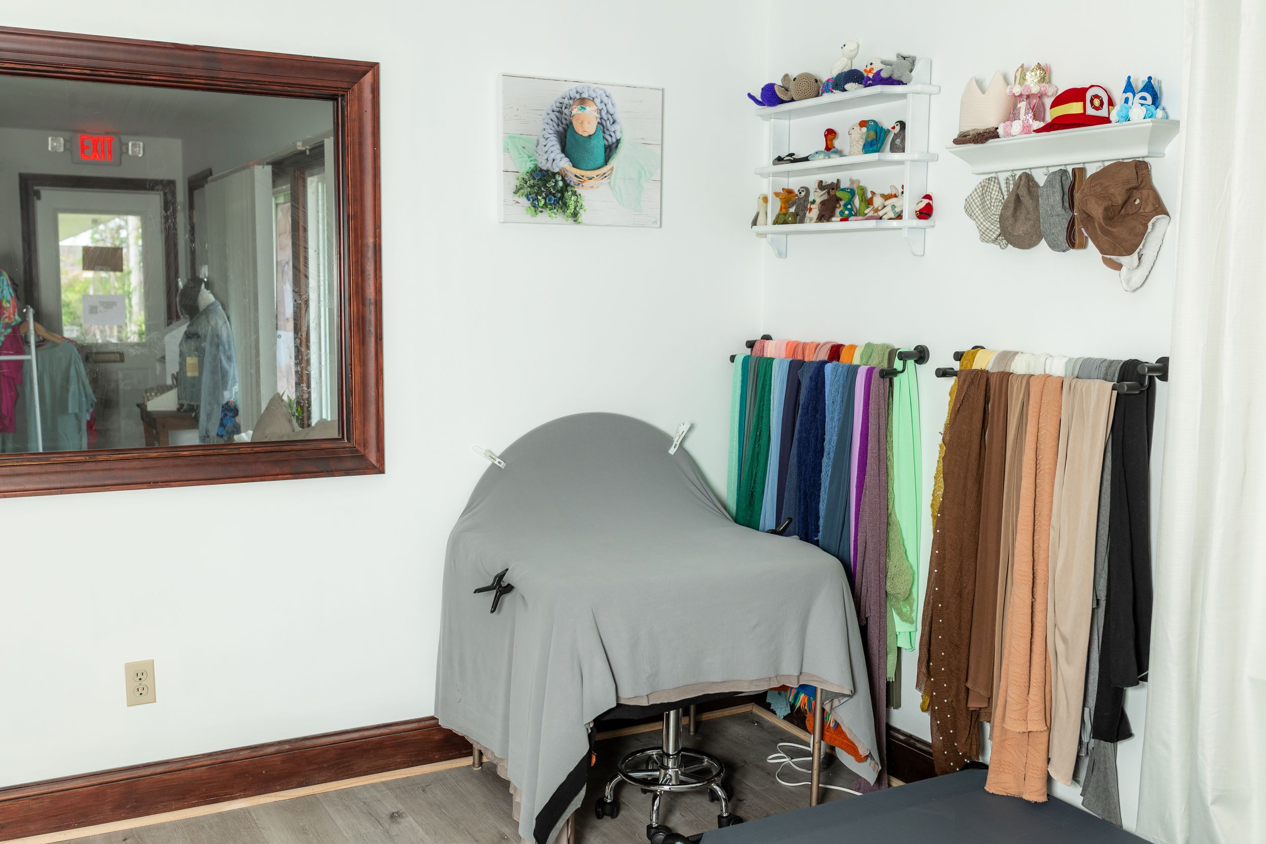 Newborn photographer preparing a calm studio environment with baby shusher and diffuser for newborn photography in Swansboro, NC.