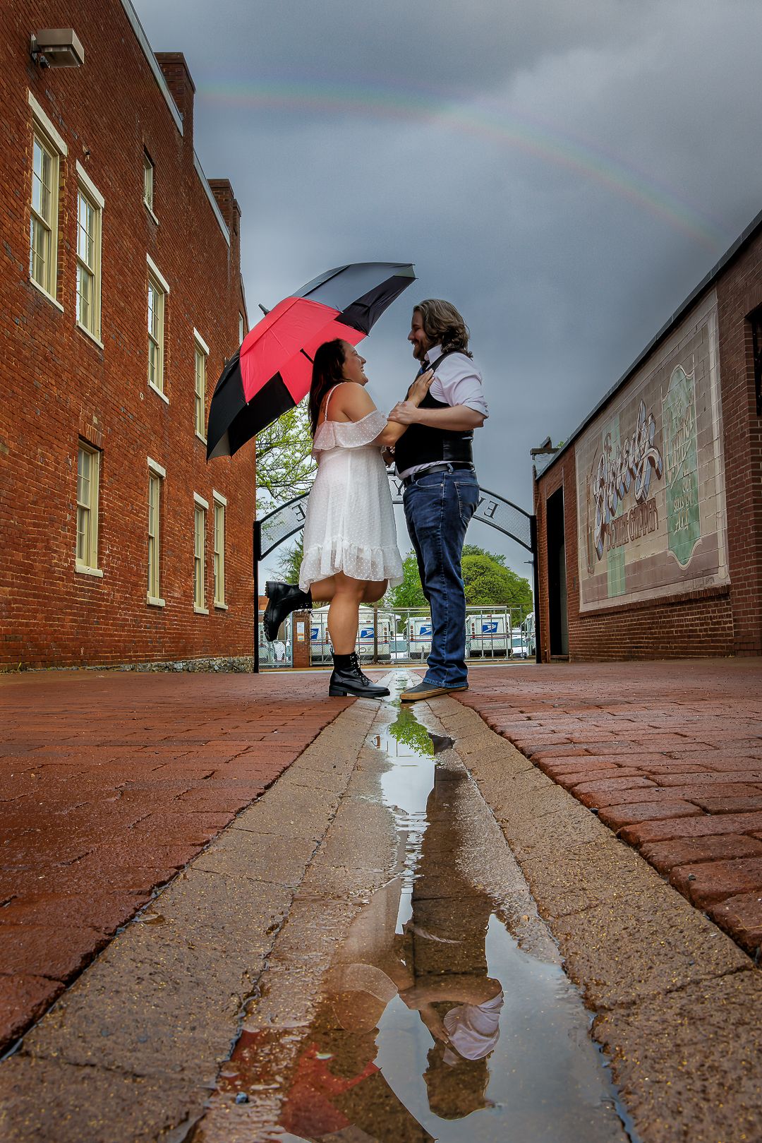 Creative puddle reflection photos showing figures with umbrellas along a brick walkway on a rainy day.