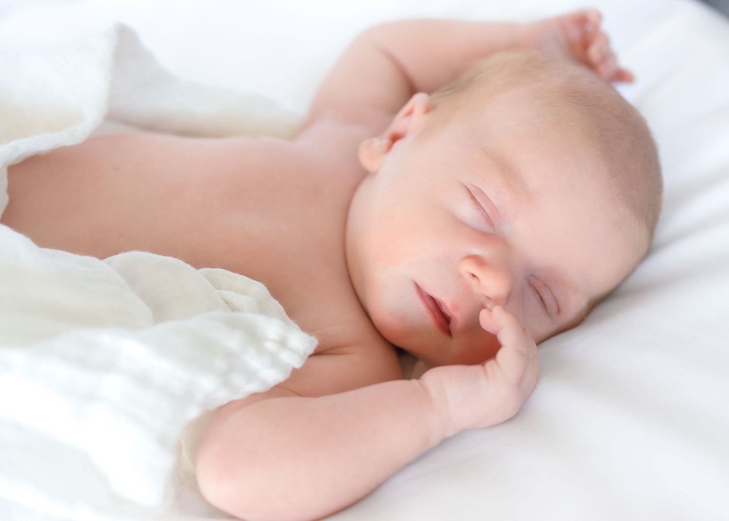 Newborn baby boy sleeping during an in-home lifestyle newborn photography session near Athens GA.