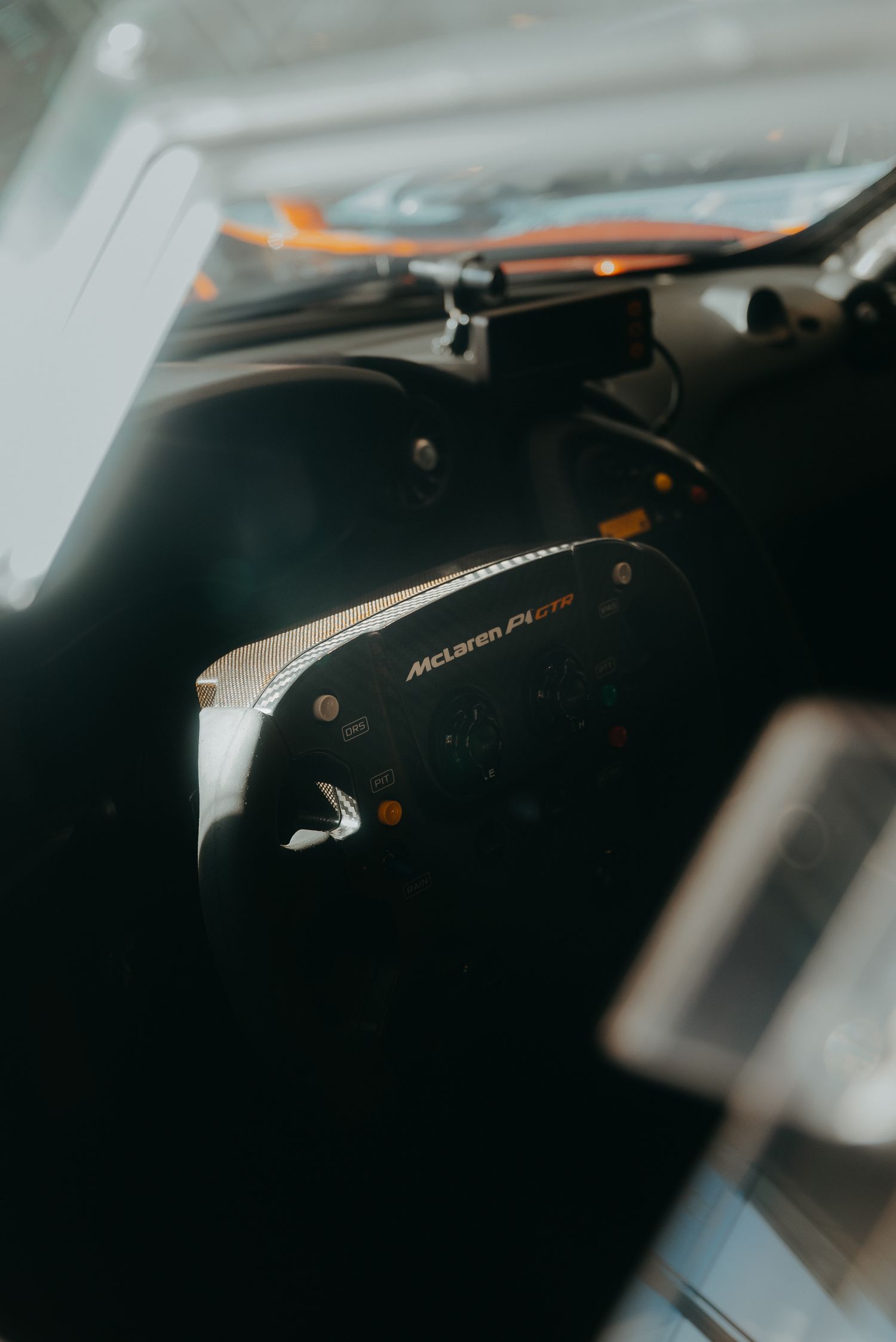 Close-up macro shots of a black computer keyboard with orange backlighting in dark environment.