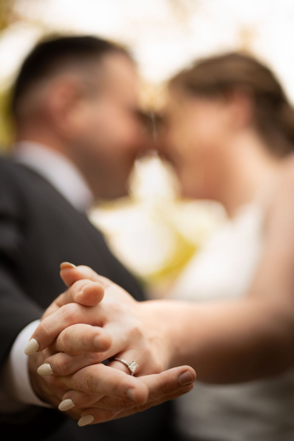 Close-up sequence of clasped hands with wedding rings showing tender moments during a ceremony.