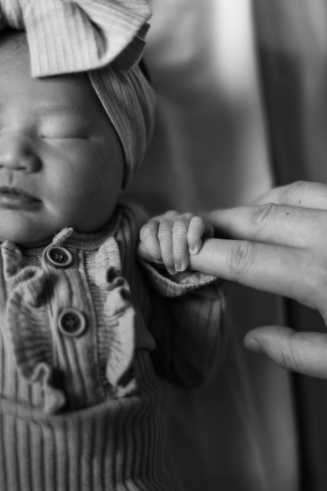 Black and white photo sequence showing fingers making silly expressions by manipulating a person's cheeks.