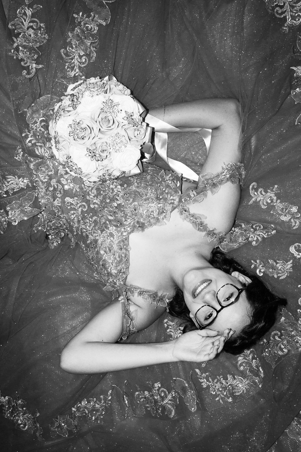 A series of black and white artistic photographs showing a reclining figure against a floral patterned background.