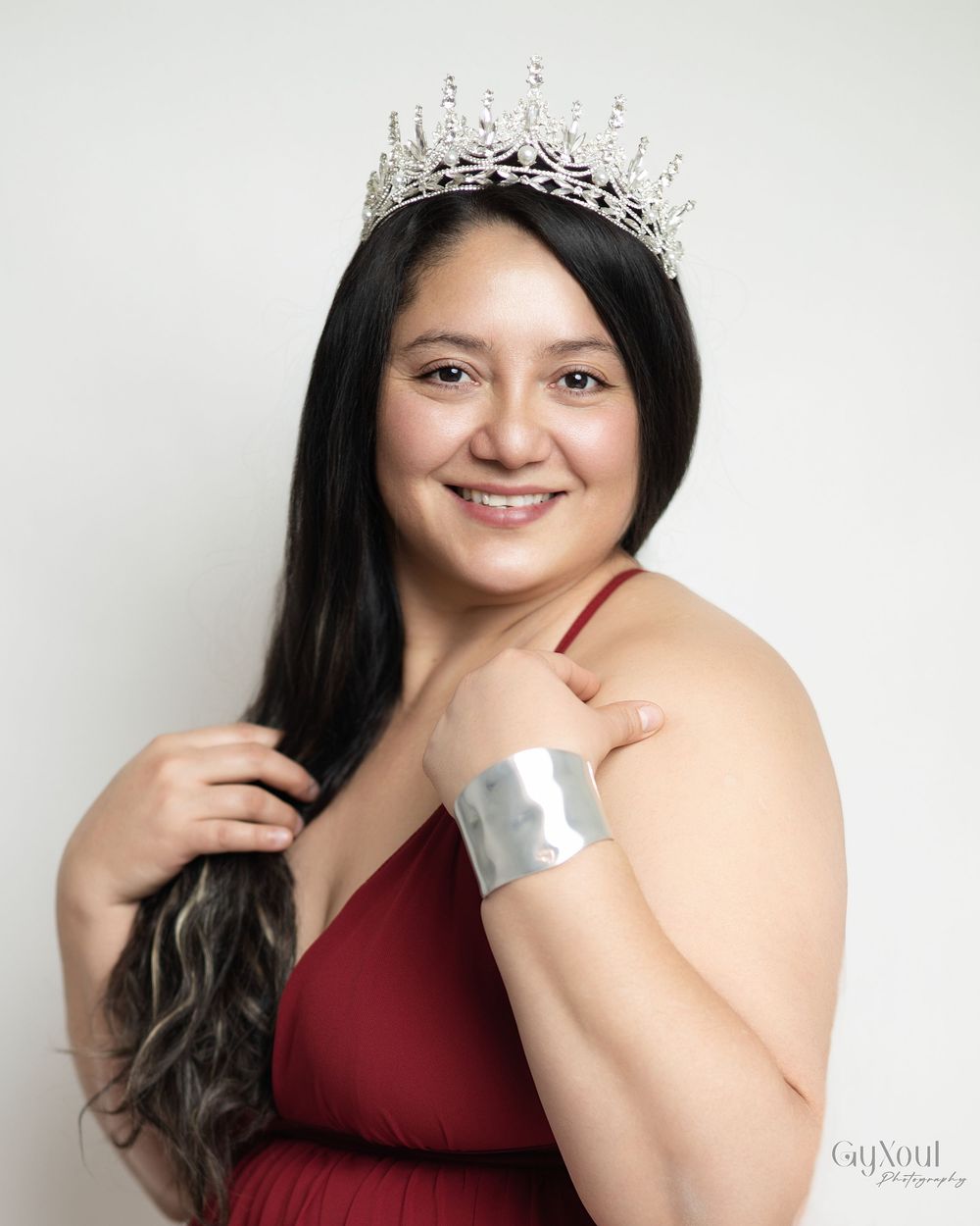 A series of five studio portraits showing someone in a burgundy dress and tiara against a light background.