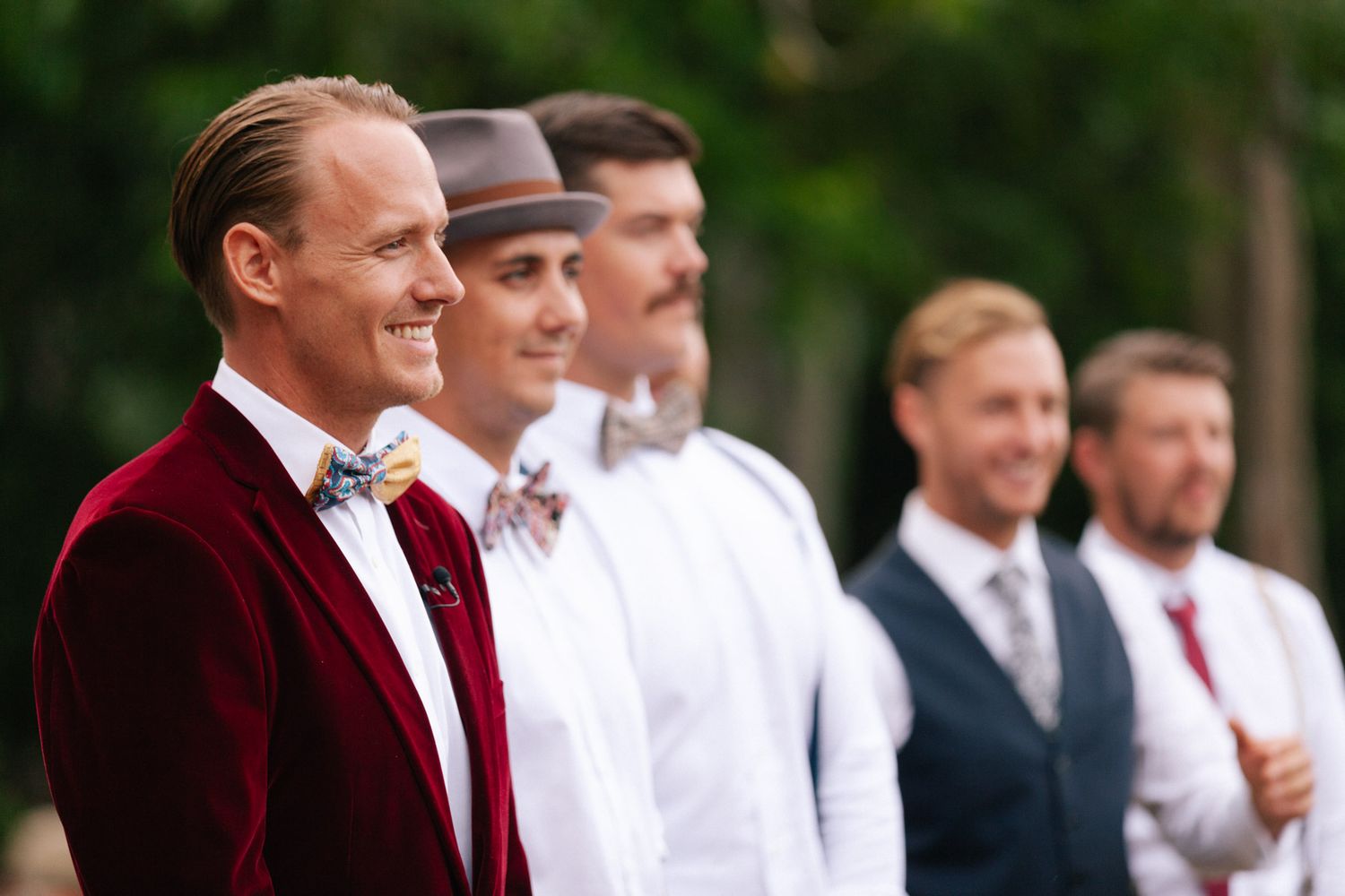 Groom in burgundy velvet blazer with groomsmen at outdoor Byron Bay hinterland wedding | DRH studio wedding Photography