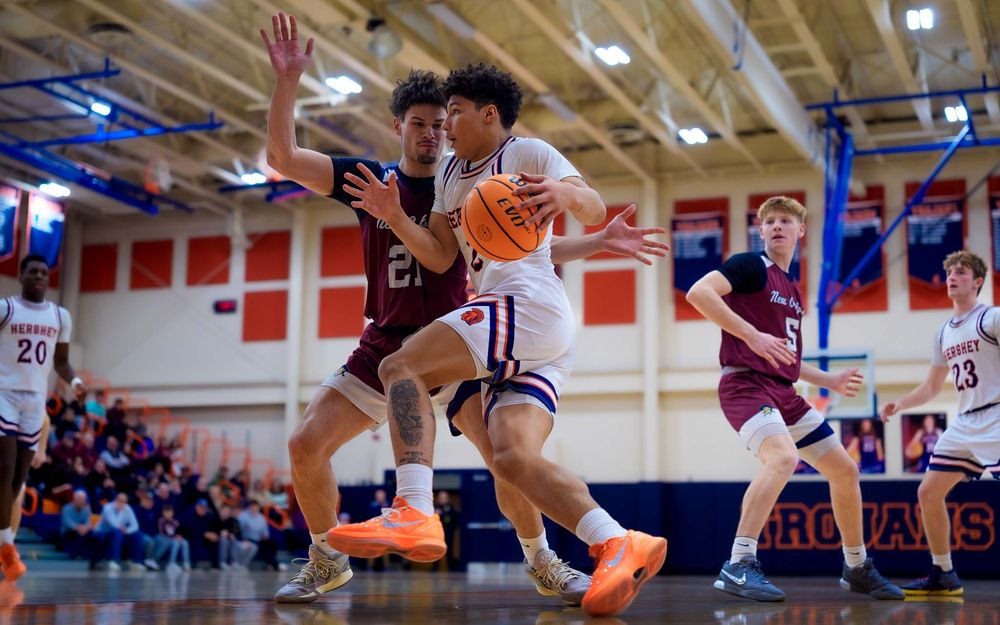 Hershey Trojans player drives hard to the hoop, weaving through New Oxford defenders by SportsFox Photography, Hershey PA.
