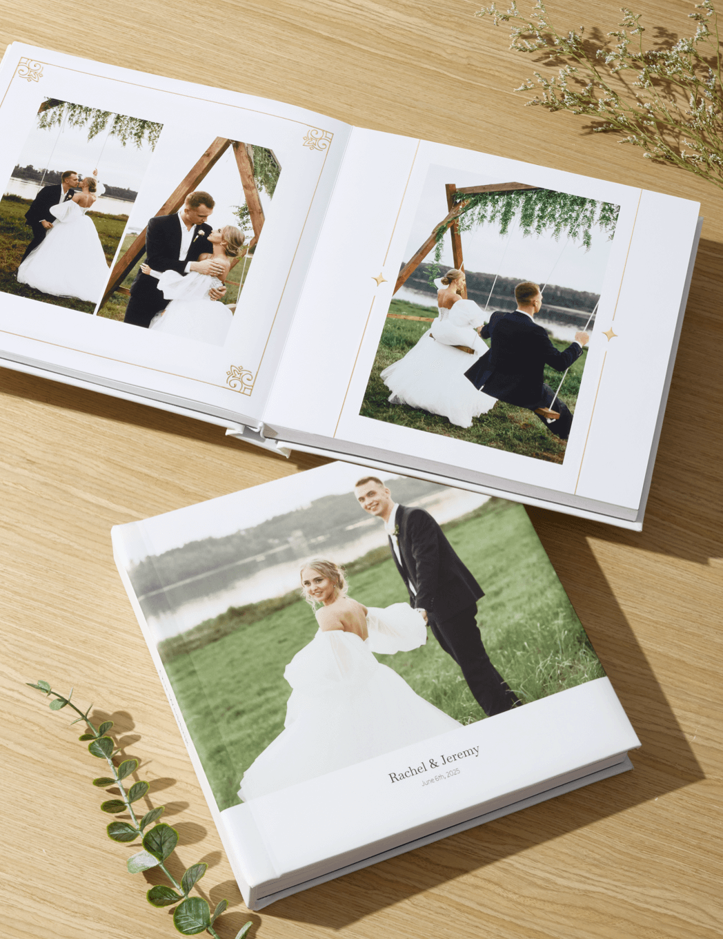 Wedding photo album with white hardcover and interior pages showing outdoor ceremony and portrait photographs on wooden surface.