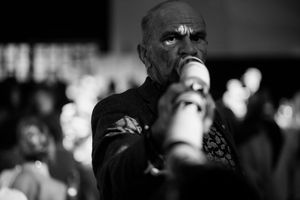 Black and white photograph capturing candid moments at a formal evening gathering.
