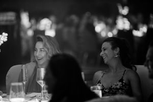 Black and white candid shots of guests enjoying a formal evening event.