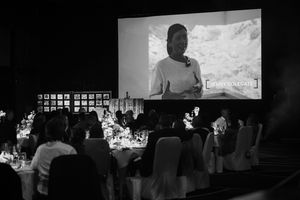 Black and white photos showing people seated in a dark theater or auditorium watching a projected screen display.