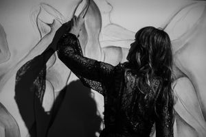 Black and white artistic photo showing silhouettes against a light background.