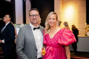 Elegant evening event with guests mingling in formal attire.