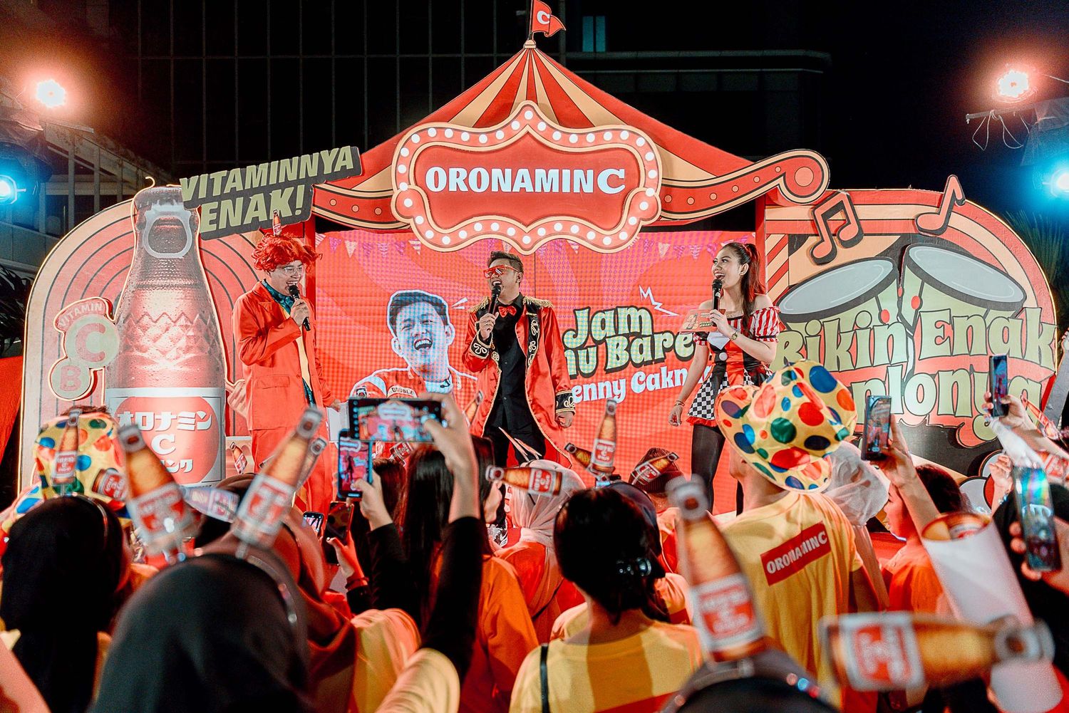 Vibrant red neon signs and decorative elements illuminate a lively nighttime festival or market scene.