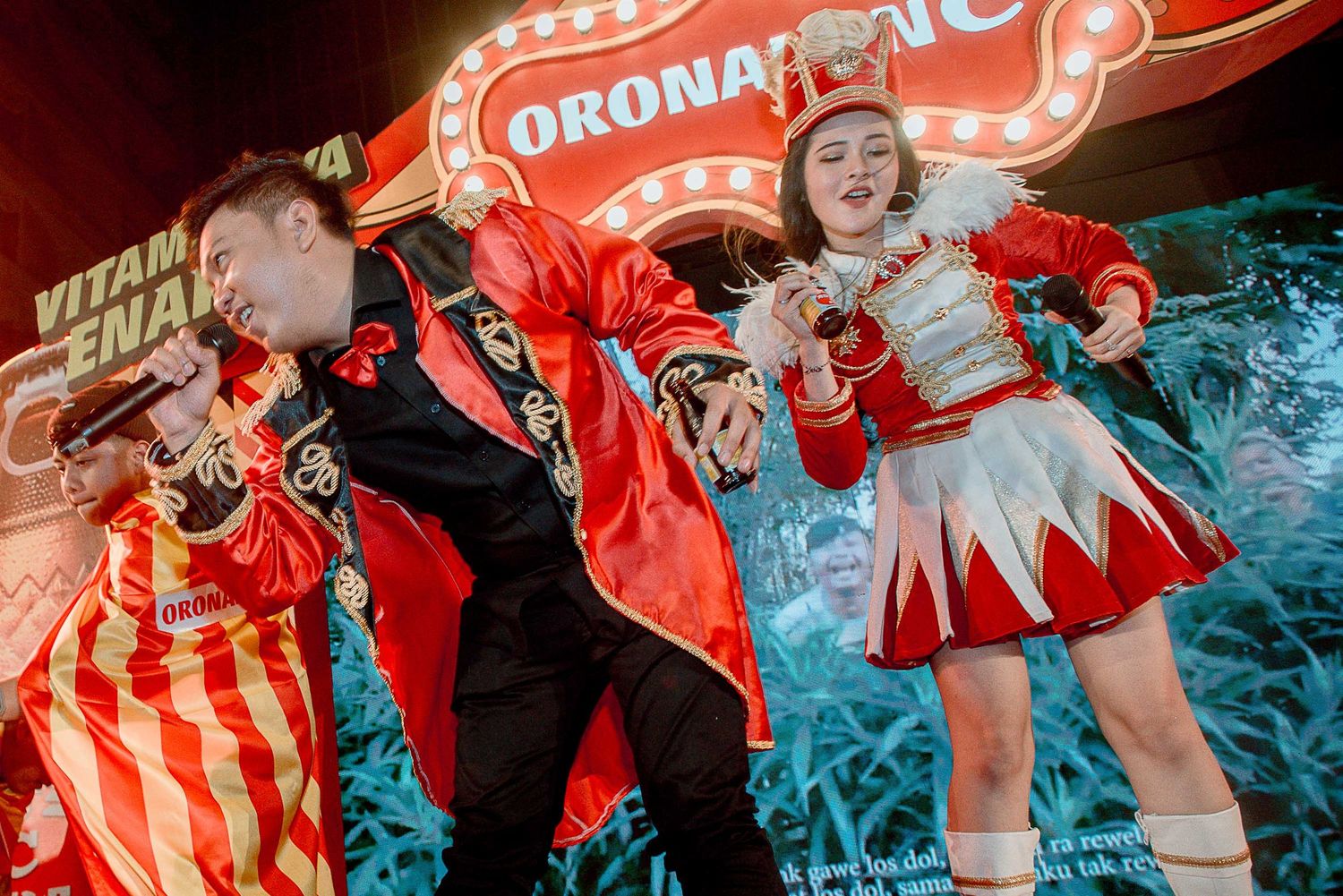 Crowd of party-goers dancing under vibrant red lighting in a nightclub atmosphere.