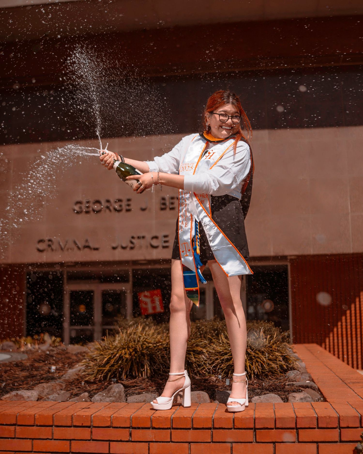 A sequence of close-up shots showing white sneakers and socks against a brick surface with water splashing in motion.