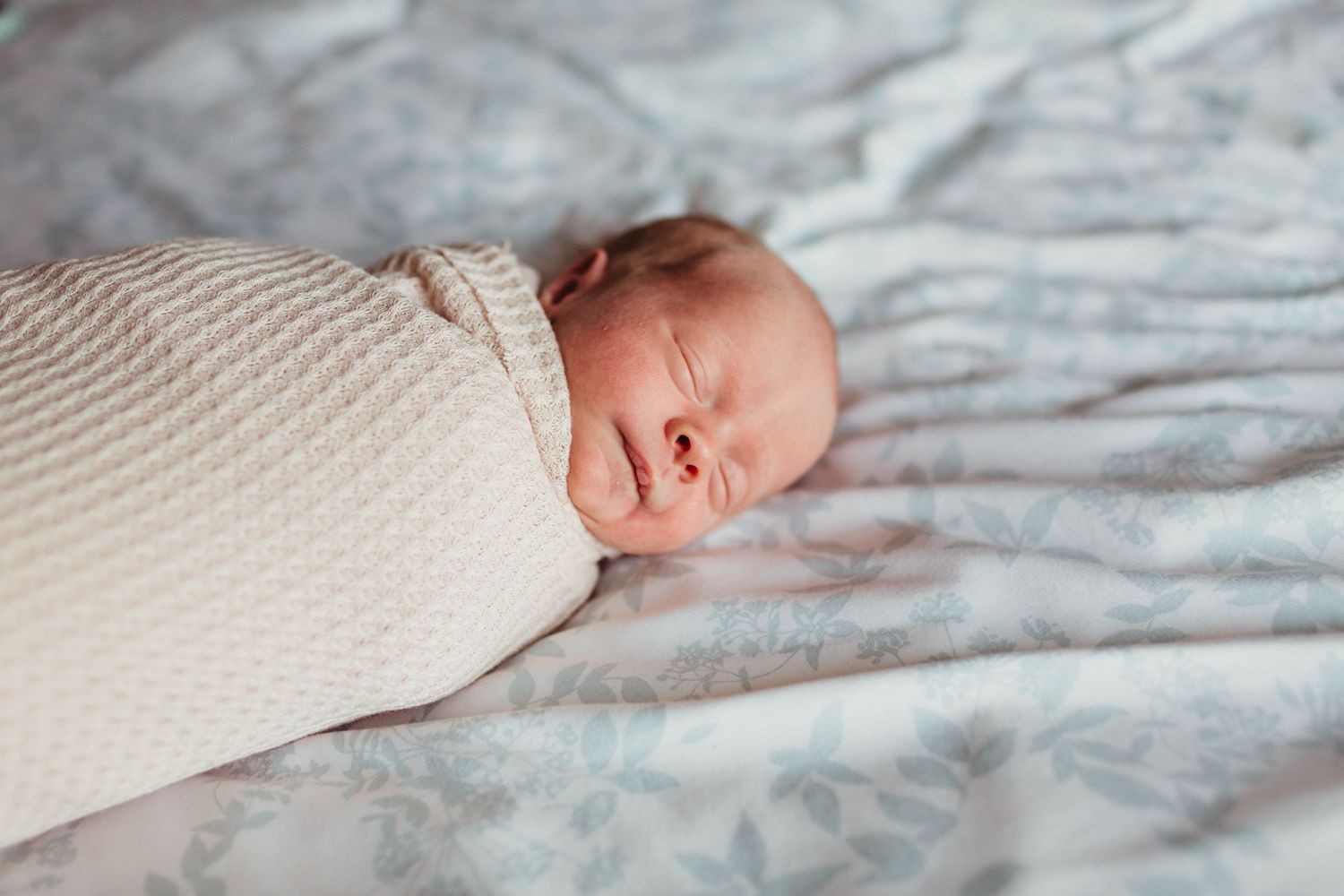 A series of close-up photos showing a baby's tiny hands and feet resting on white textured bedding.