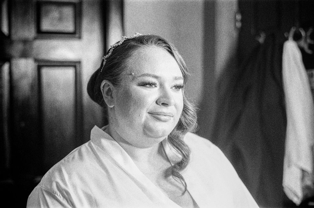 Candid black and white wedding moments showing joyful expressions during an indoor celebration.