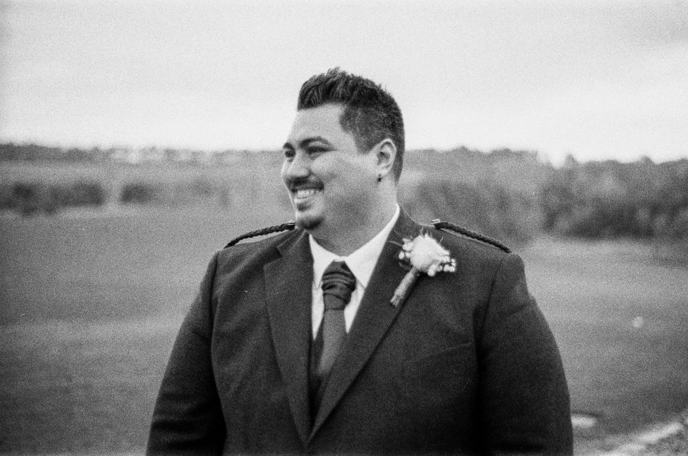 A black and white panoramic collage of people in formal attire at an outdoor event.