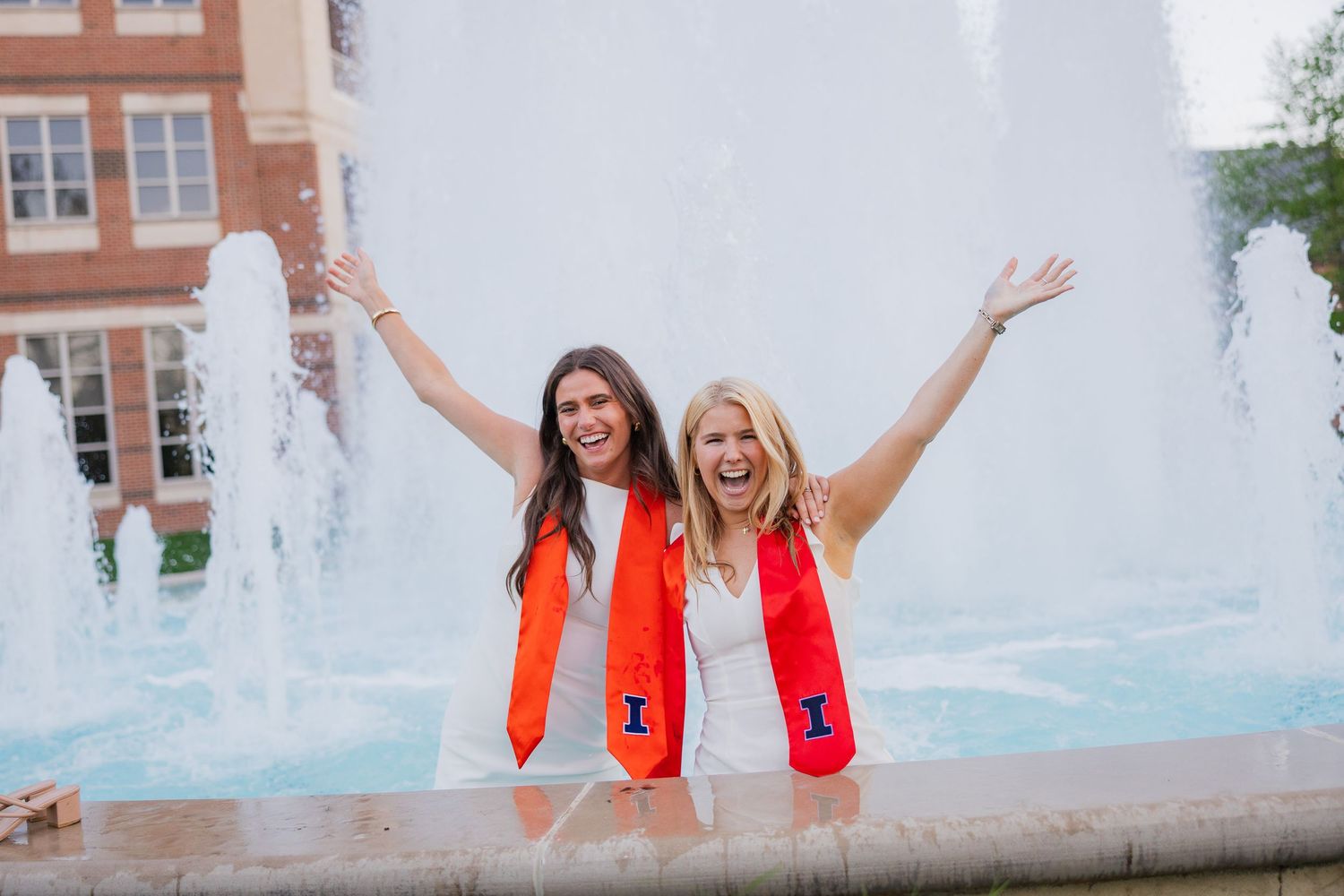 UIUC graduation photo with two girls in the fountain laughing