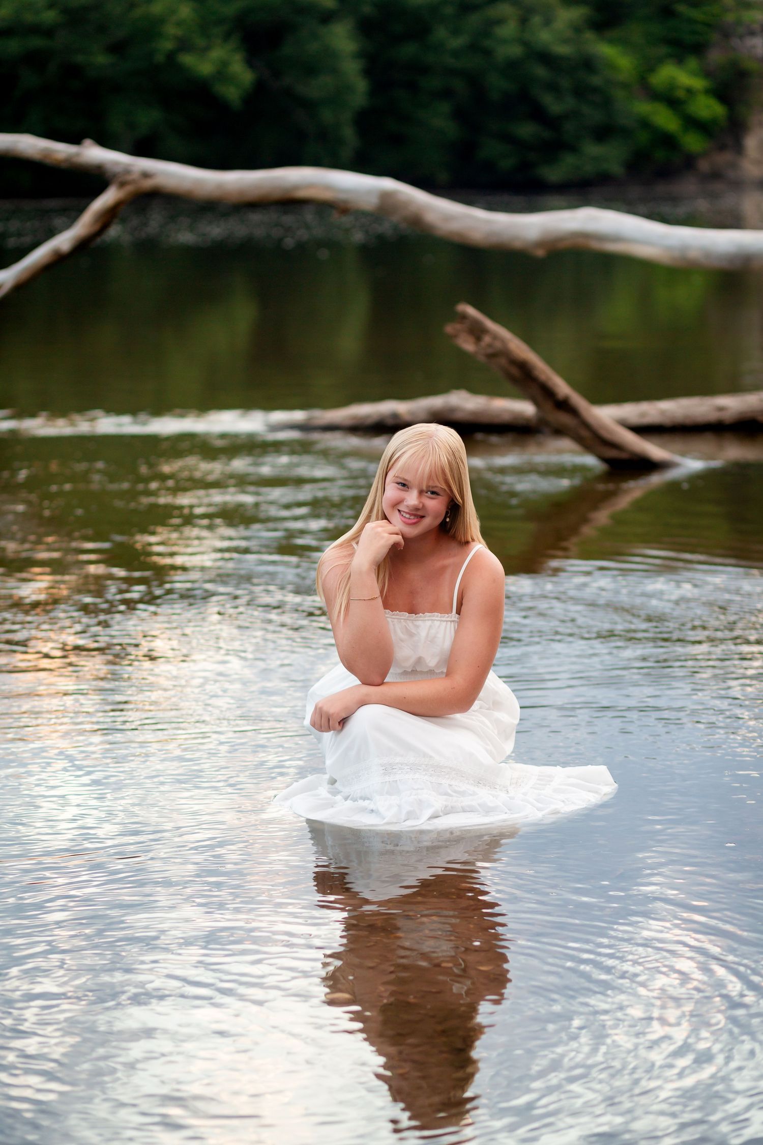 Palisades-Keperler park high school senior photo of a girl in a white dress in the water near golden hour with Nichole Sieck Photography.