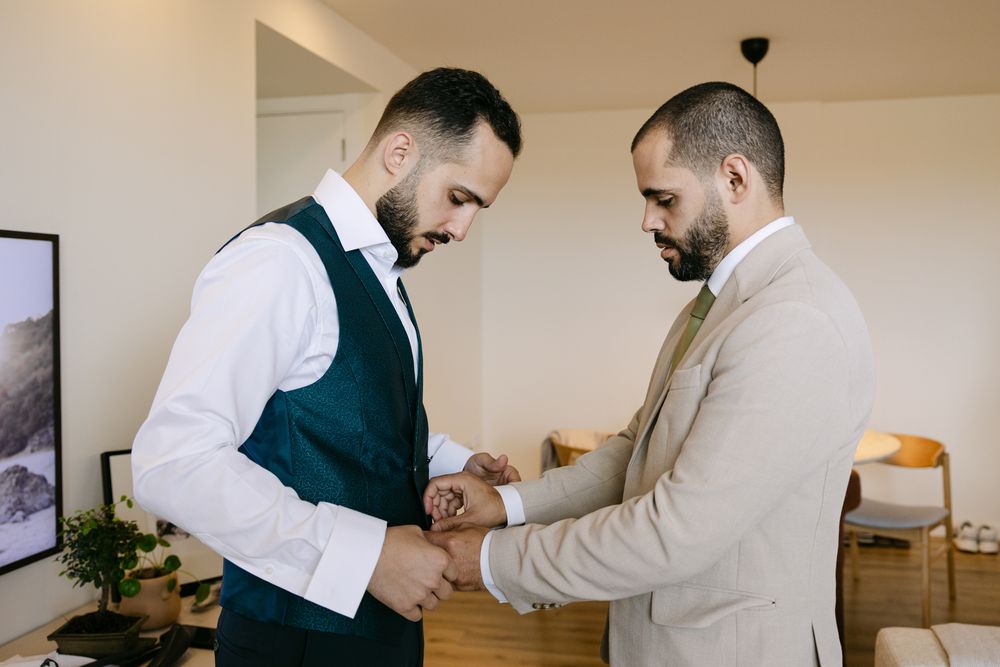 Groom adjusting jacket before leaving for Solar de Pancas