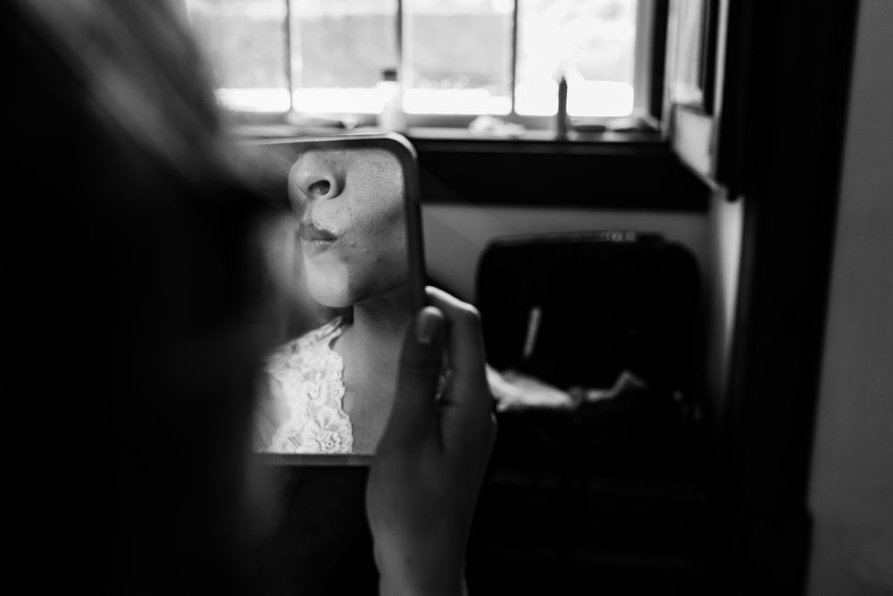 Bride having makeup applied during wedding morning