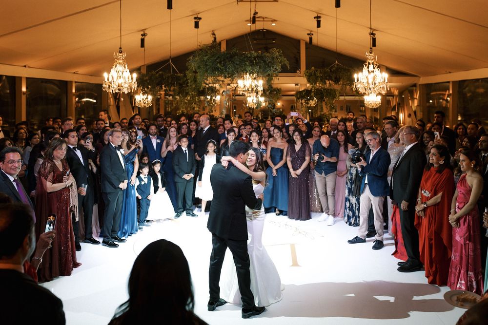 Bride and groom first dance surrounded by guests at luxury Indian wedding reception in Portugal at Corrio-Mor palace