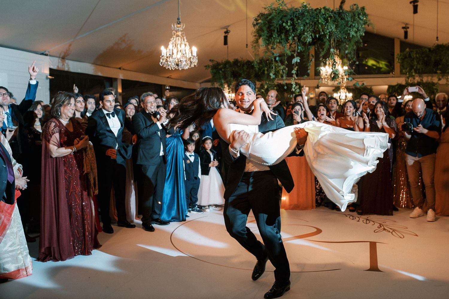 Bride and groom first dance surrounded by guests at luxury Indian wedding reception in Portugal at Corrio-Mor palace