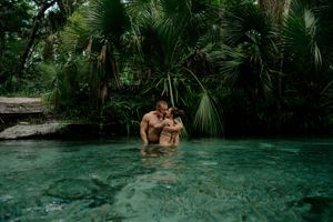 A series of tranquil swimming spots in a lush tropical cenote with crystal clear turquoise waters and palm trees.