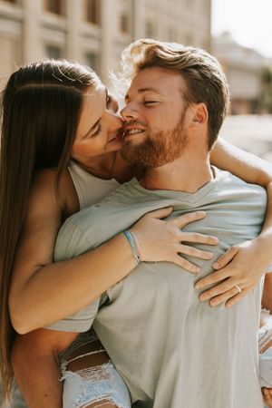 Intimate close-up shots of a couple embracing and sharing tender moments outdoors.