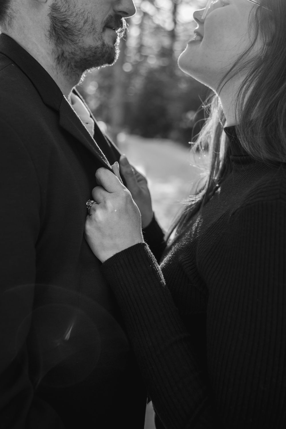 Intimate black and white close-up portraits showing tender moments between a couple.