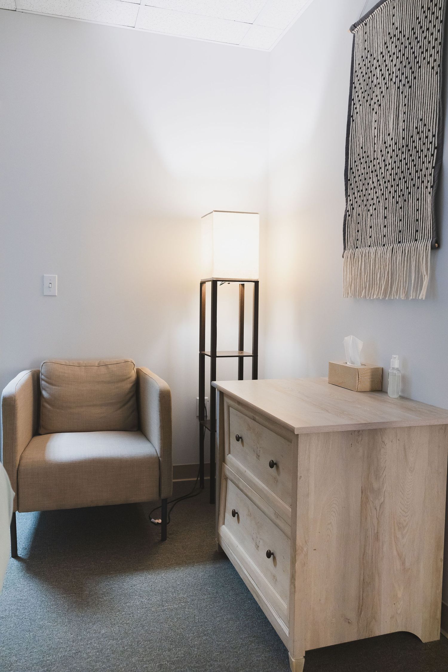 Maple Valley Acupuncture, WA branding photo of treatment room where clients sit during intake session: chair, floor lamp, desk, wall decor