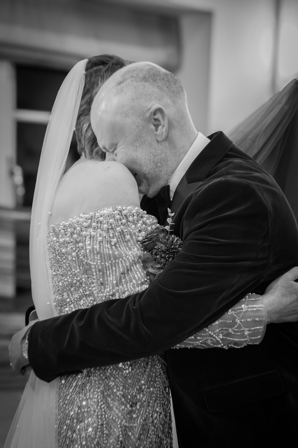 A tender black and white sequence of a father hugging his daughter in her sparkly wedding dress on her special day.