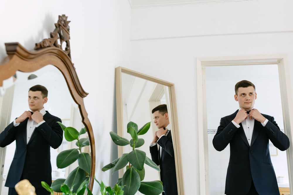 groom triple reflection during getting ready at quinta nova do hespanhol