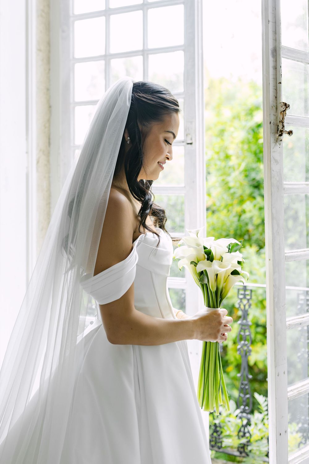 Angela adjusting her veil in soft autumn light before ceremony in Lisbon