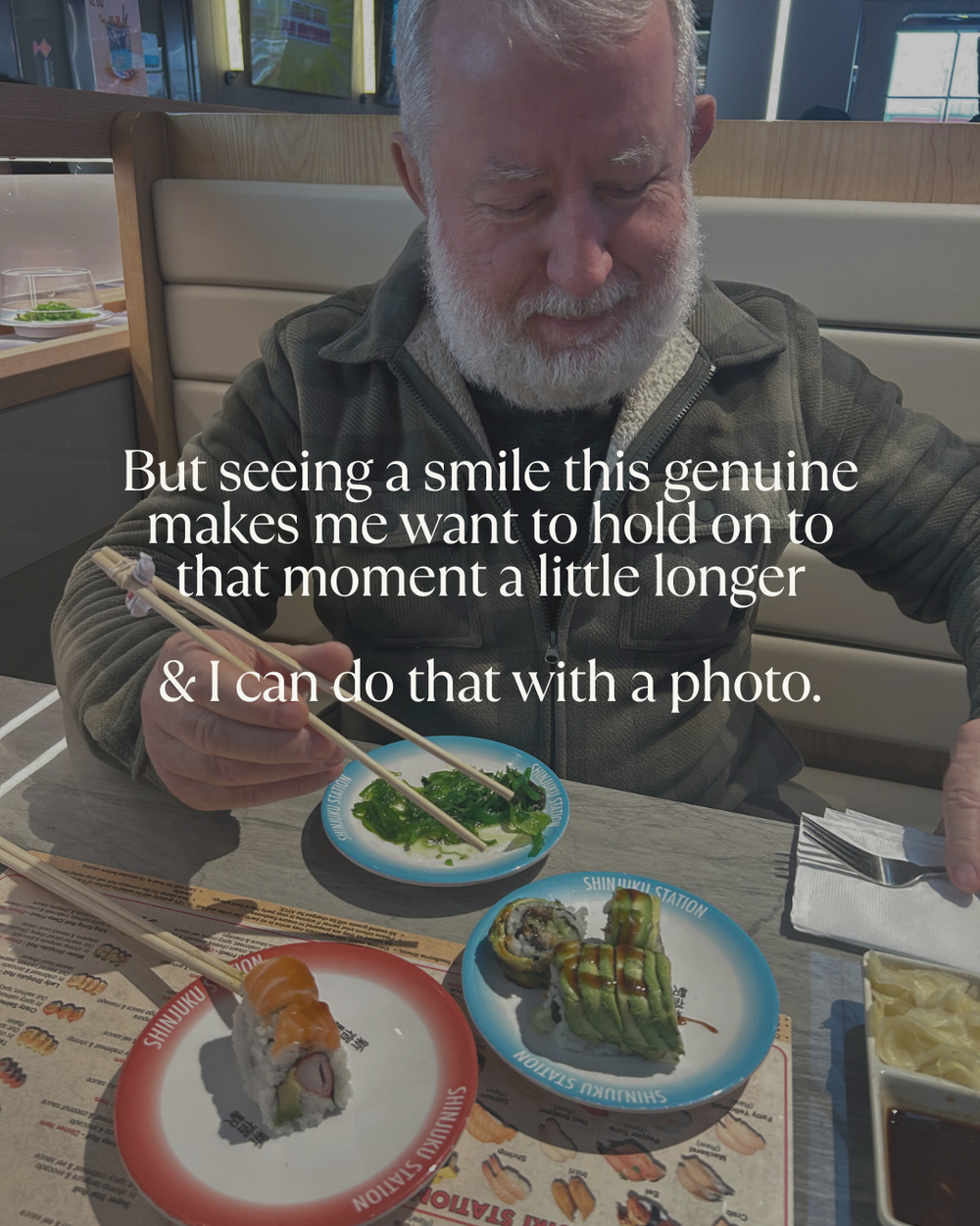 Someone with a white beard sits at a restaurant table with multiple plates of food while reading text overlaid about capturing moments.