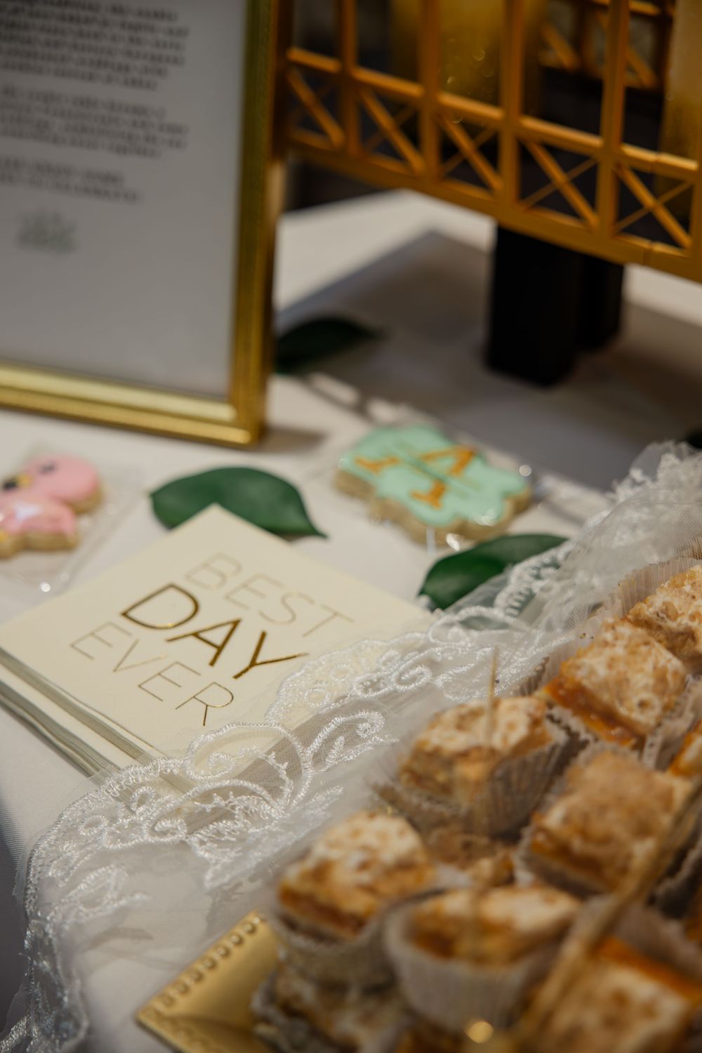 Close-up view of pastries in clear plastic packaging with gold lettering on display at a bakery counter.