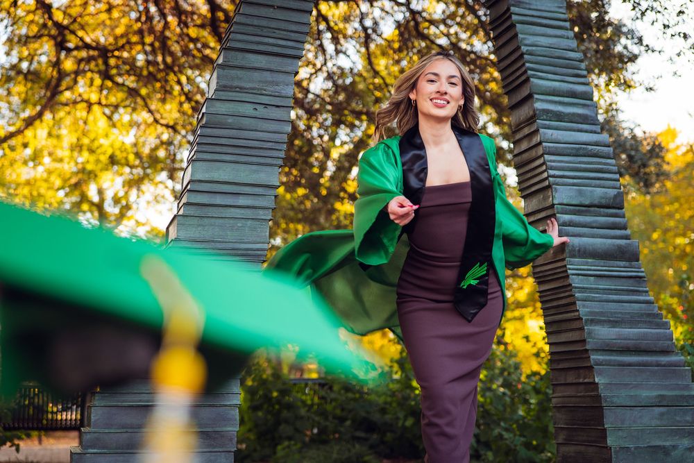 Autumn graduation photos with golden sunlight filtering through trees. UNT Graduate Portraits by Eric Aaberg Photography in DFW.