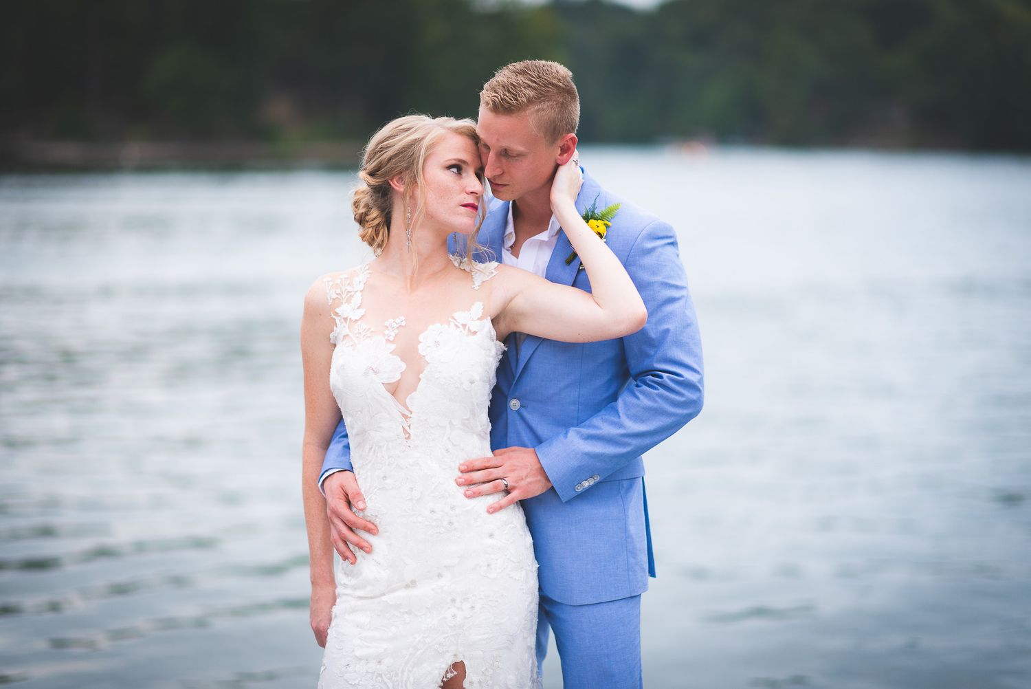 Beautiful couple kissing during their wedding on a lake in central Indiana