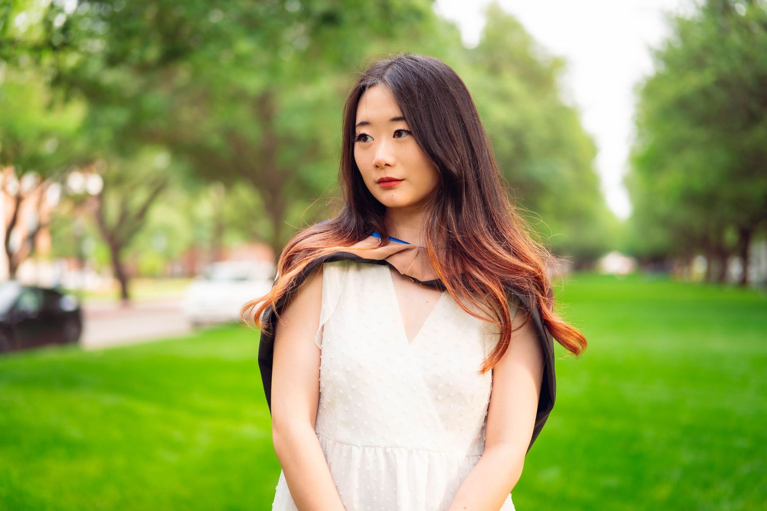 Portrait session in a lush green park setting on a sunny day.