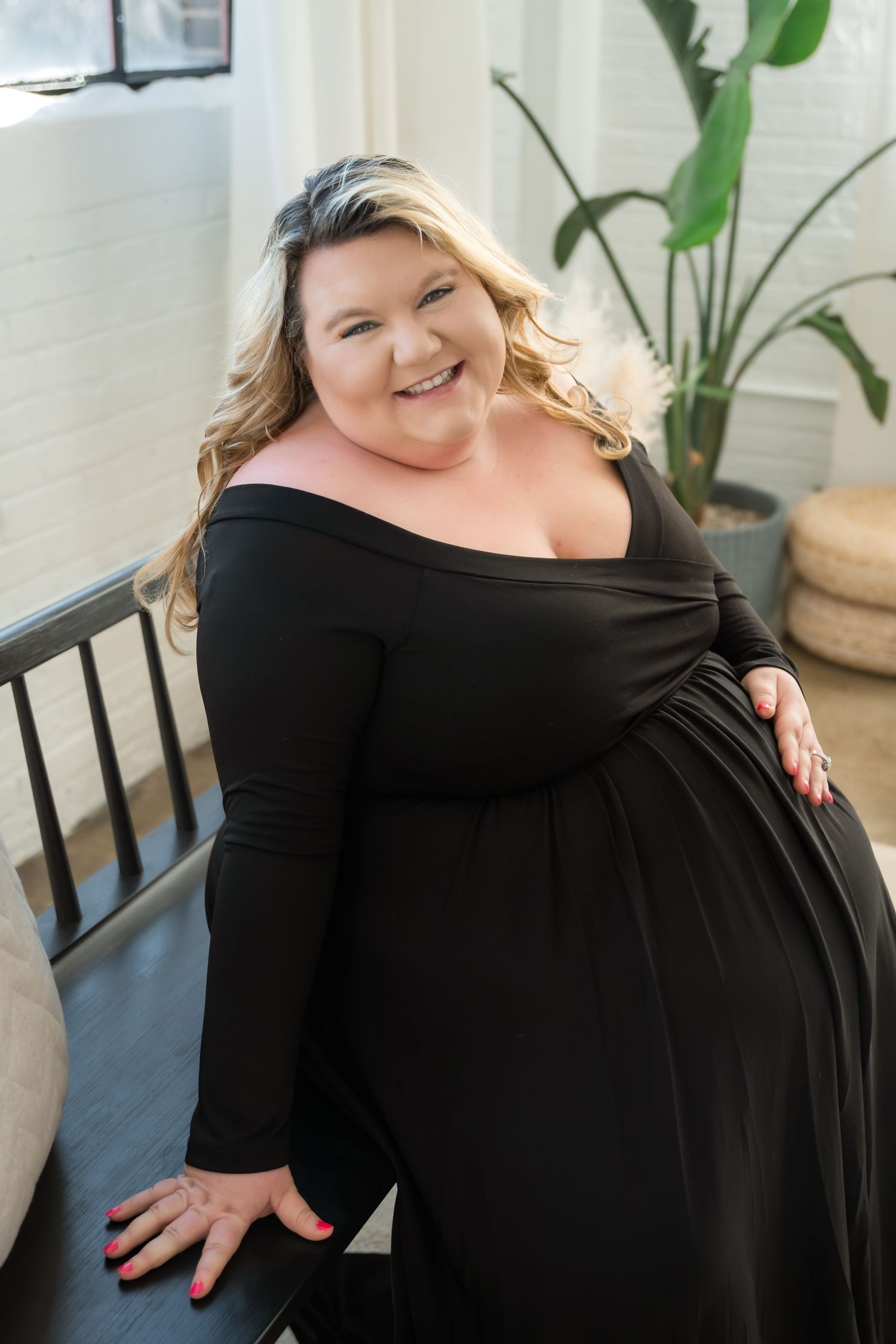 Woman in black off-shoulder dress poses confidently in multiple shots showing different angles and expressions.