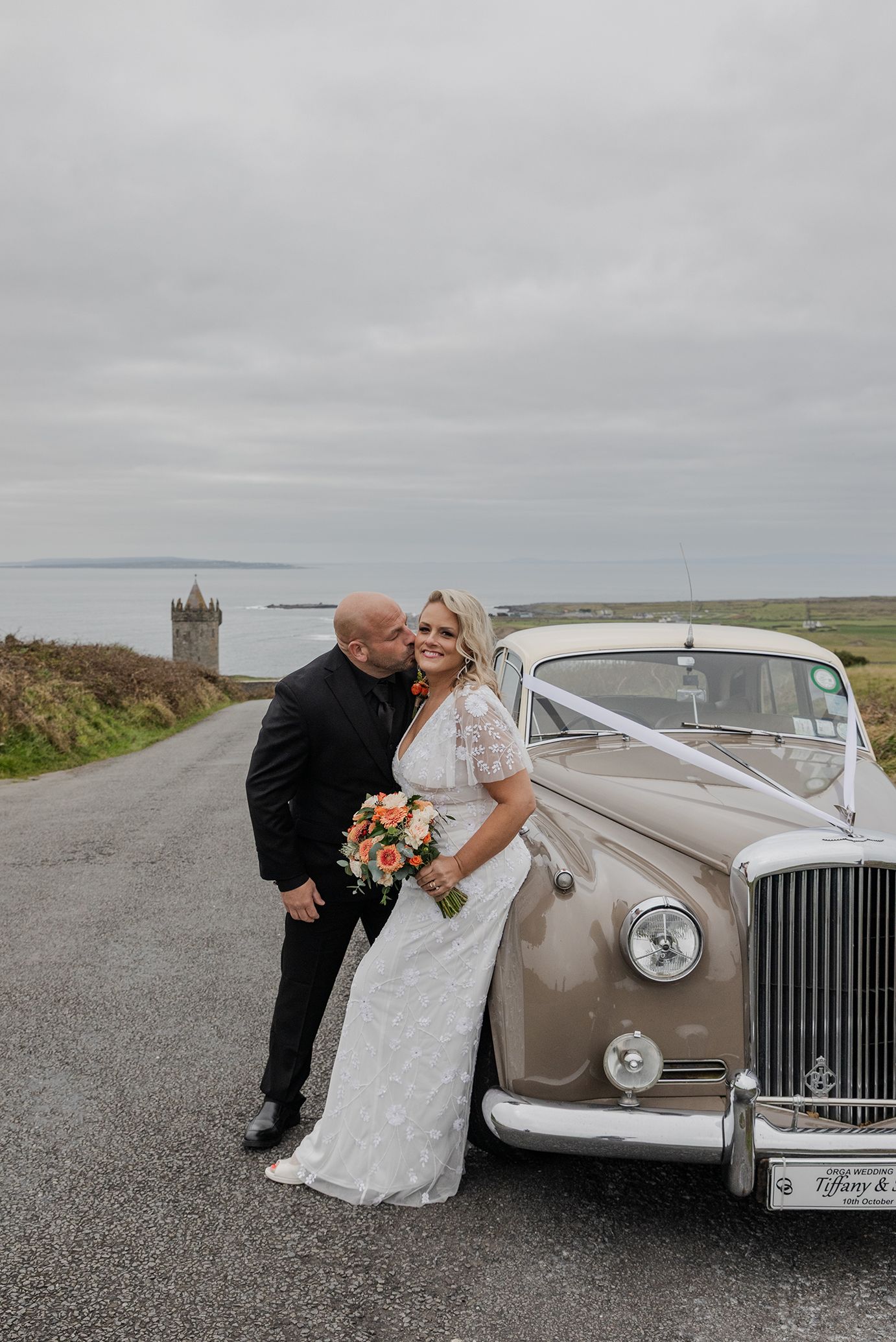 Bride and groom exploring Doonagore Castle after cliffside ceremony.