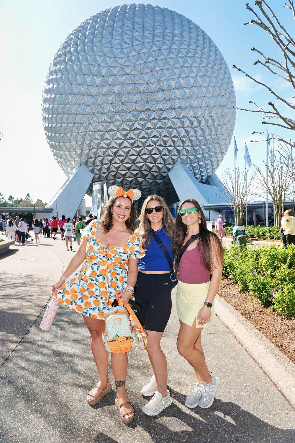 A series of five photos showing people posing in front of the iconic Spaceship Earth sphere at EPCOT theme park.