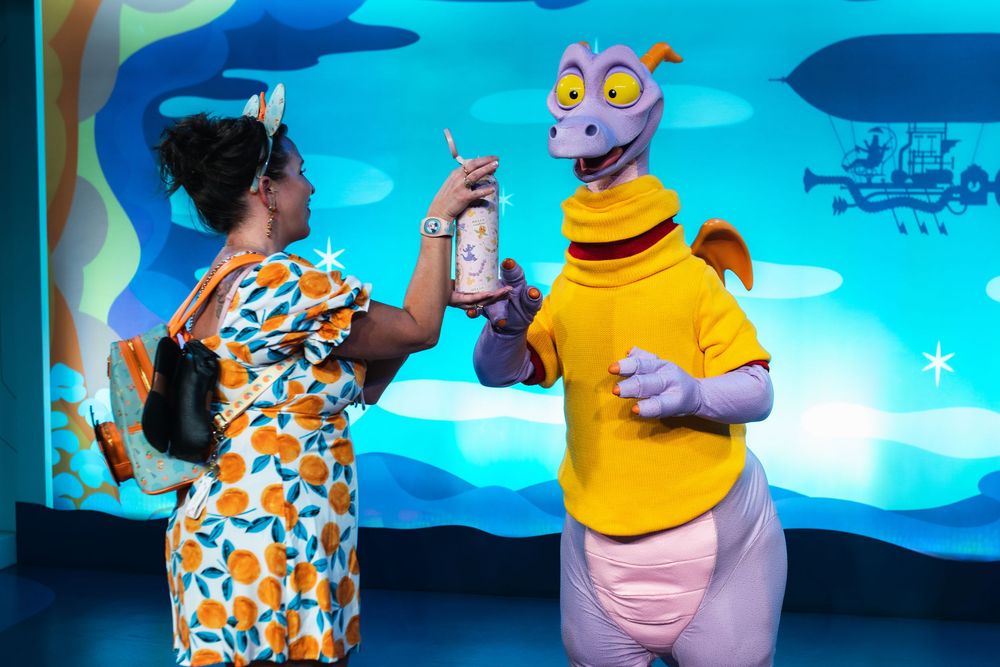 Animated characters from a theme park show perform against a bright blue background in a sequence of action shots.
